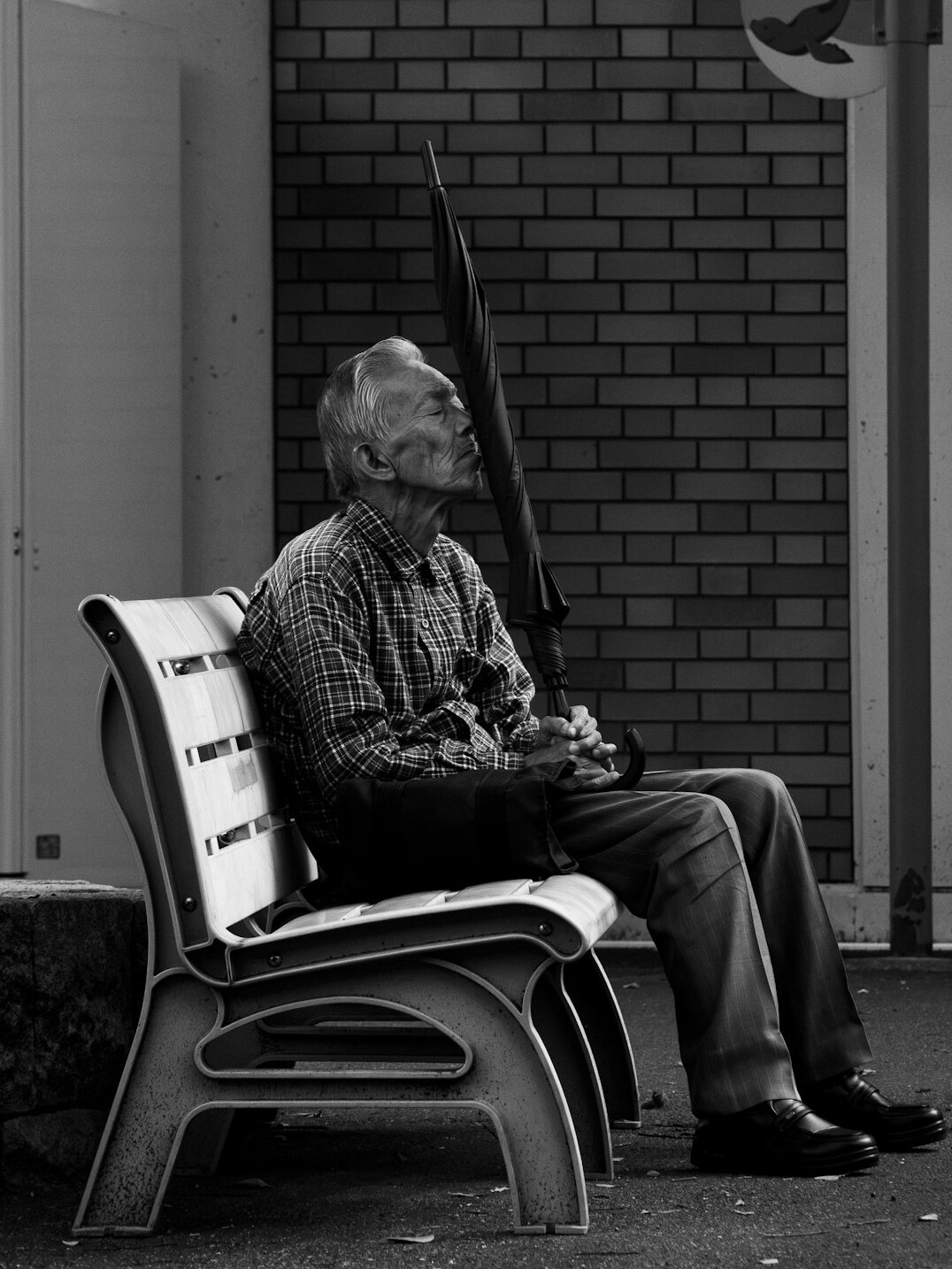elderly man sitting on bench
