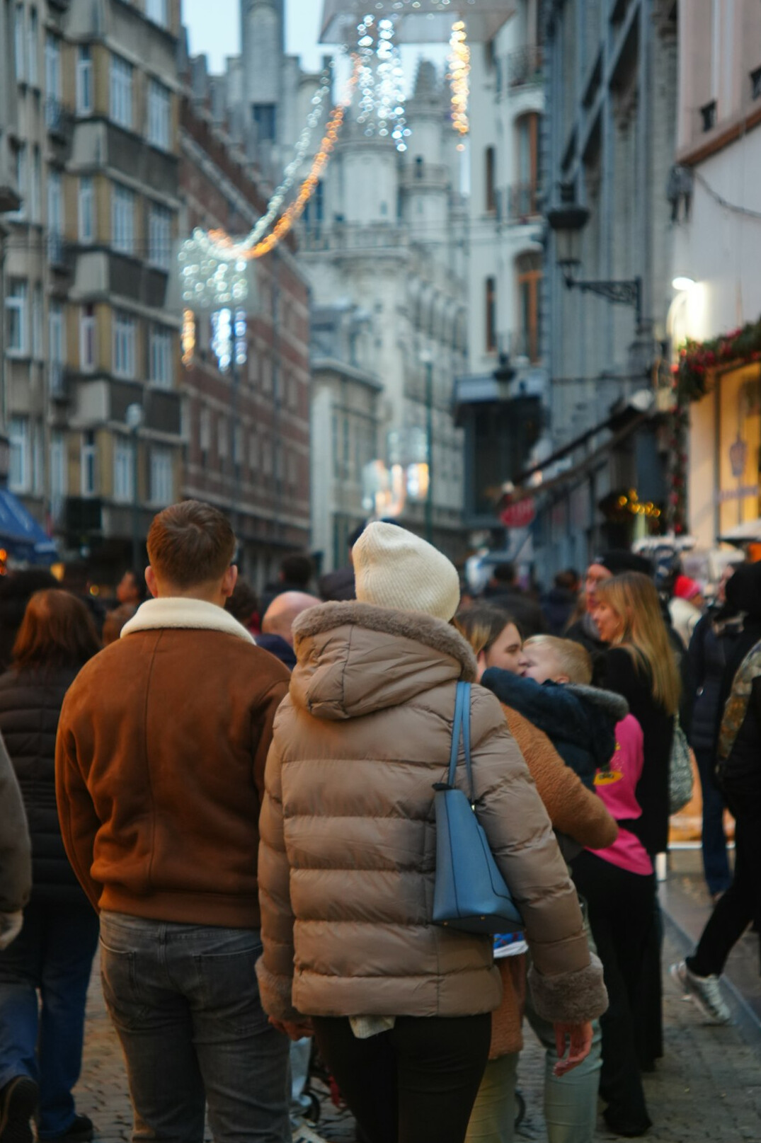 people waiting in queue on city street